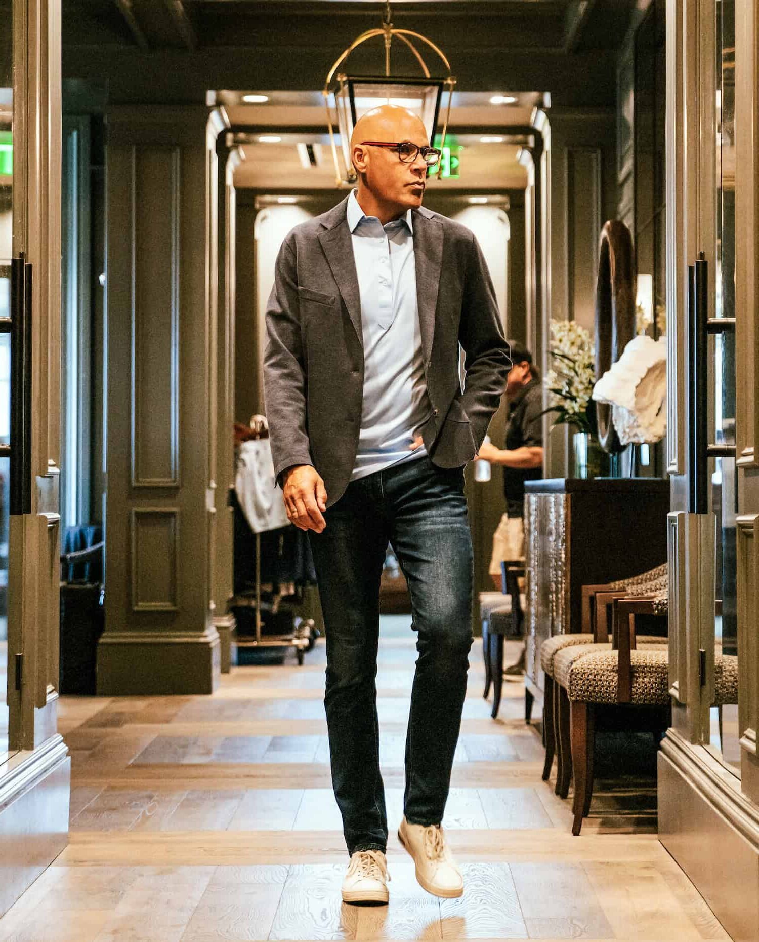 Full-length photo of CEO Chris Flakus walking forward, demonstrating executive presence and forward-thinking leadership in the professional staffing industry.