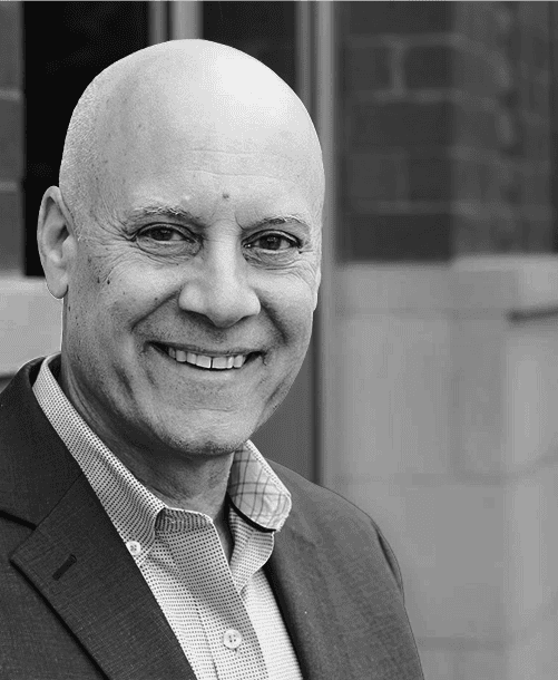 Black and white portrait of Steve Frey, Global HR Leader, providing a testimonial for CEO Chris Flakus's business acumen and leadership in the staffing industry.